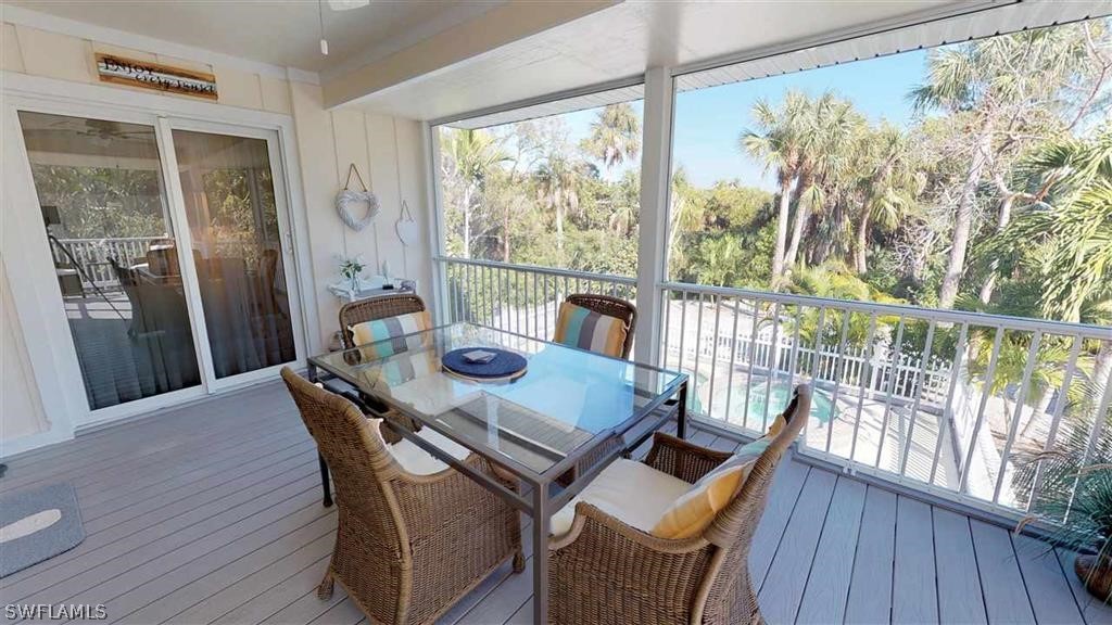 5186 Sea Bell Road Sanibel, FL 33957 - Photo 22 of 33 a view of a dining room with furniture window and wooden floor