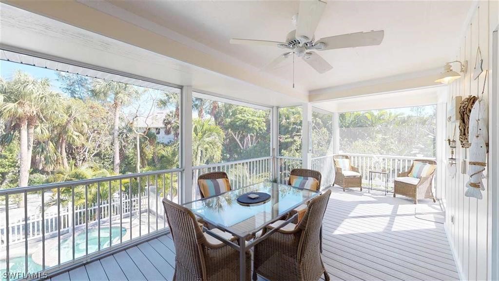5186 Sea Bell Road Sanibel, FL 33957 - Photo 23 of 33 a view of a dining room with furniture large windows and wooden floor