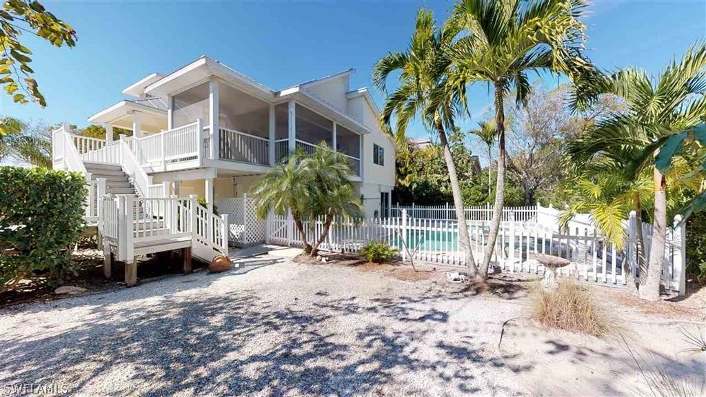 5186 Sea Bell Road Sanibel, FL 33957 - Photo 31 of 33 a view of a house with a yard and sitting area
