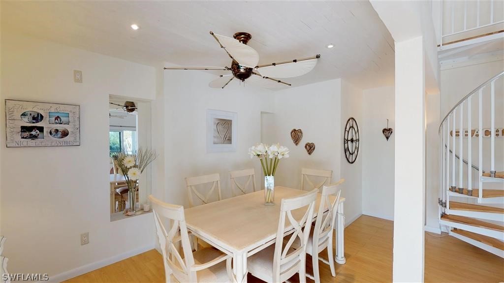 5186 Sea Bell Road Sanibel, FL 33957 - Photo 8 of 33 a view of a dining room with furniture and wooden floor
