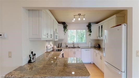 5186 Sea Bell Road Sanibel, FL 33957 - Photo 10 of 33 a kitchen with granite countertop a sink stainless steel appliances and cabinets