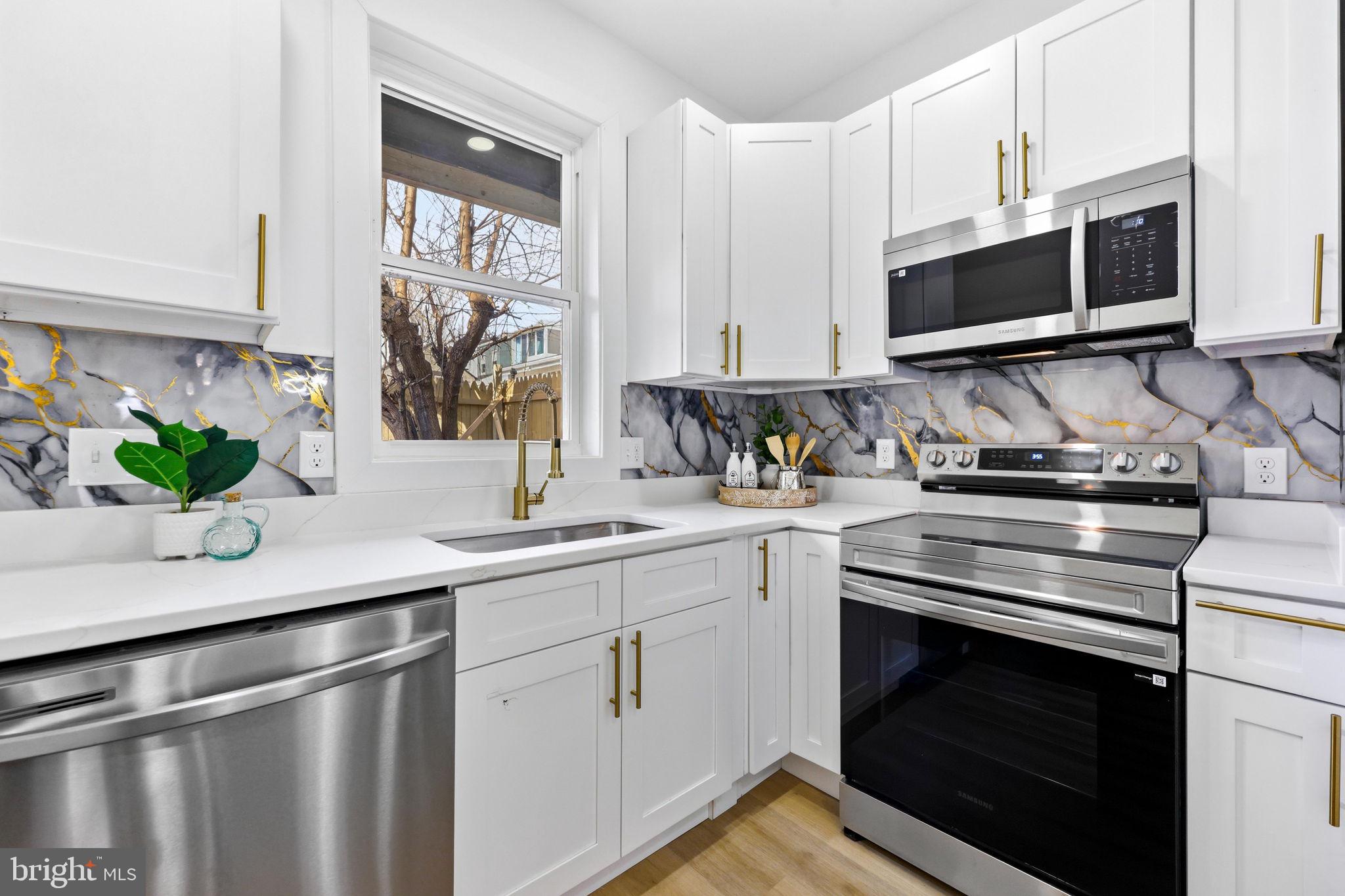3618 Keswick Road Baltimore, MD 21211 - Photo 12 of 39 a kitchen with stainless steel appliances a stove microwave and sink