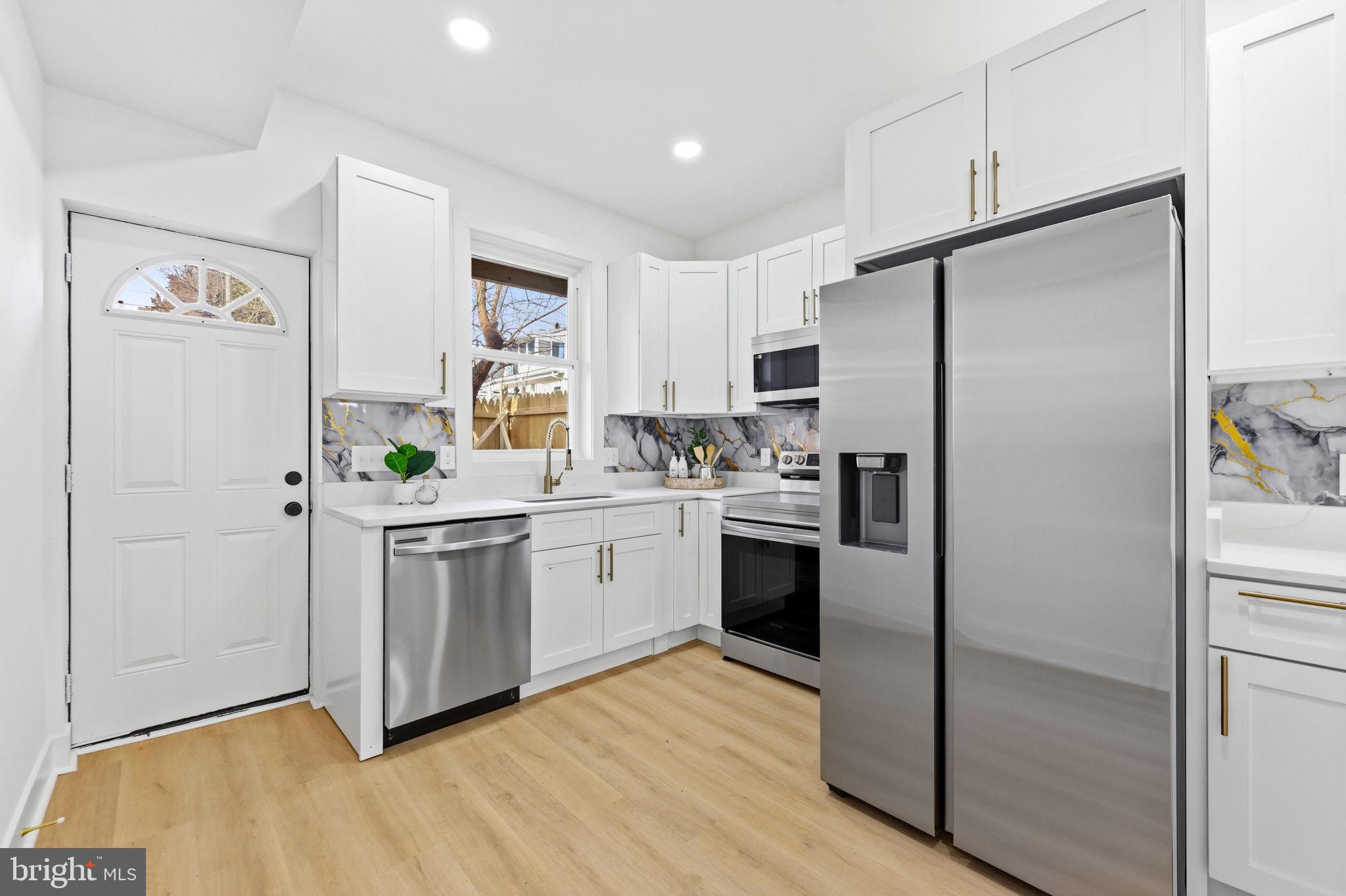 3618 Keswick Road Baltimore, MD 21211 - Photo 15 of 39 a kitchen with stainless steel appliances a refrigerator sink and microwave