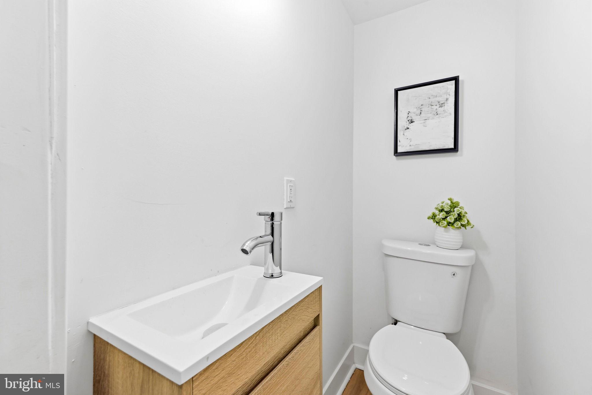 3618 Keswick Road Baltimore, MD 21211 - Photo 18 of 39 a white toilet sitting next to a bathroom sink