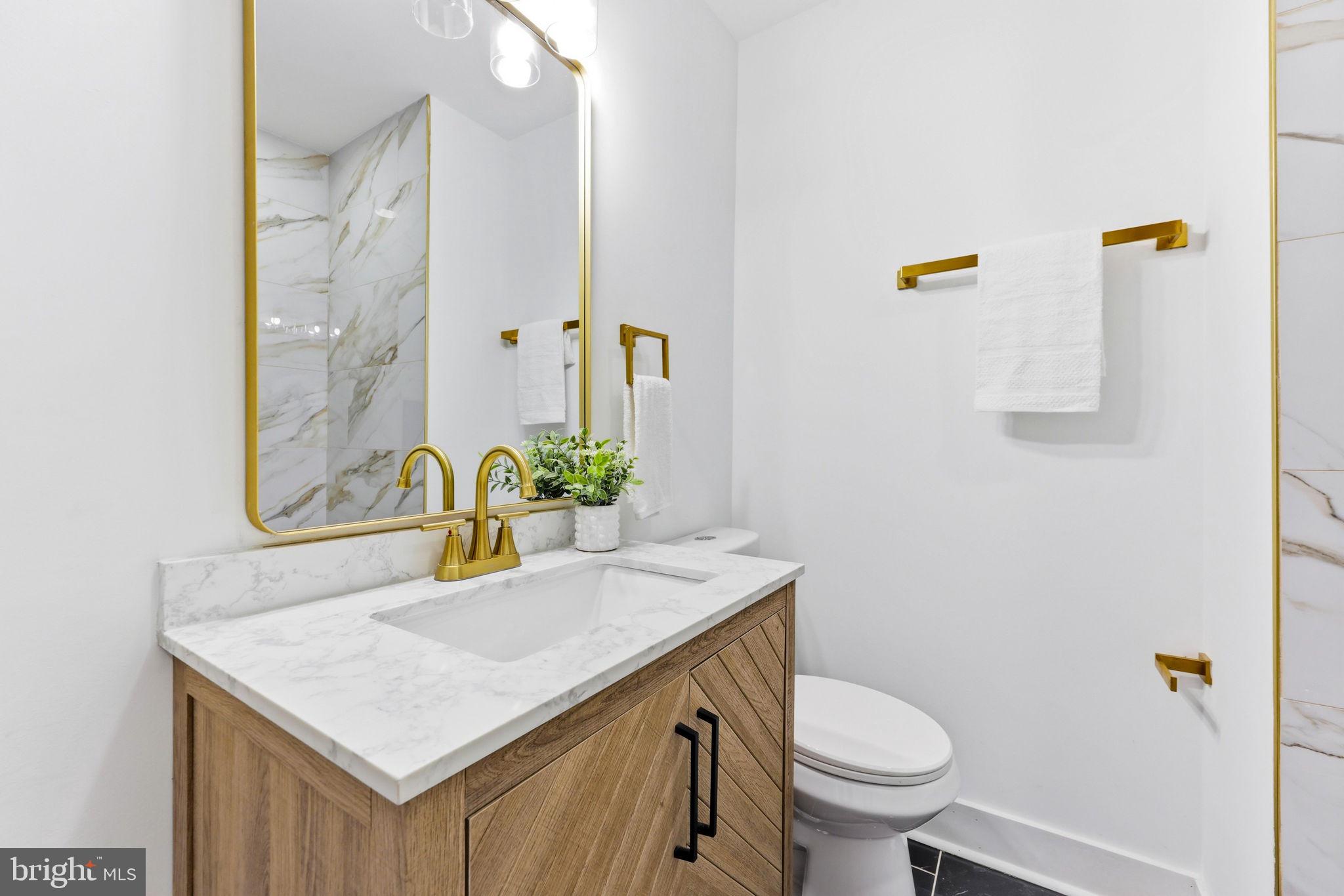 3618 Keswick Road Baltimore, MD 21211 - Photo 31 of 39 a bathroom with a sink toilet and mirror