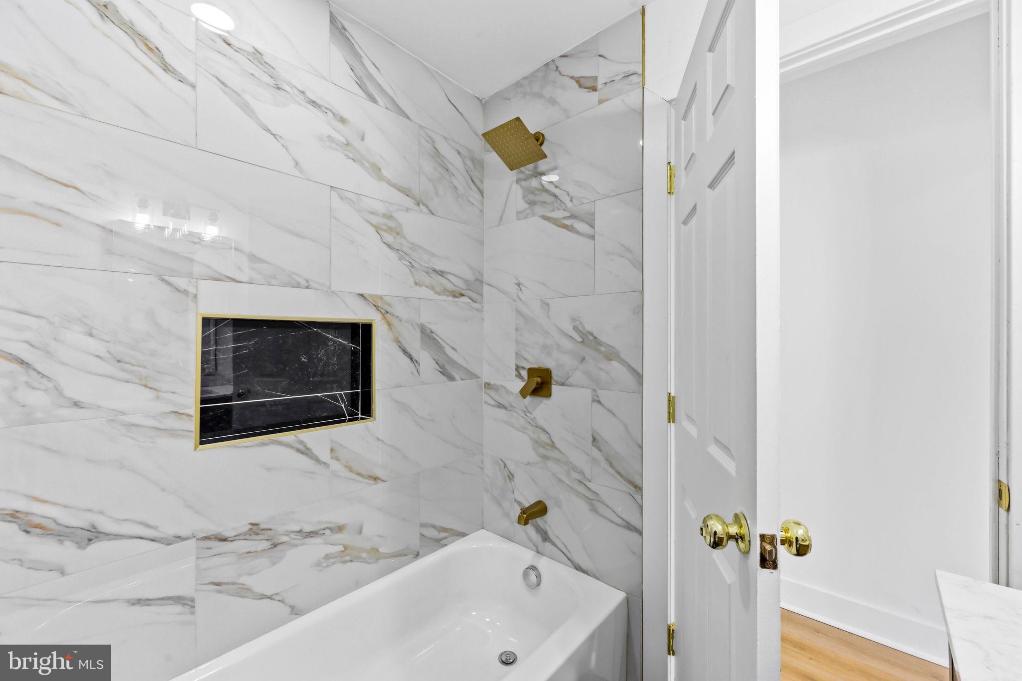 3618 Keswick Road Baltimore, MD 21211 - Photo 32 of 39 a bathroom with a bathtub and a shower