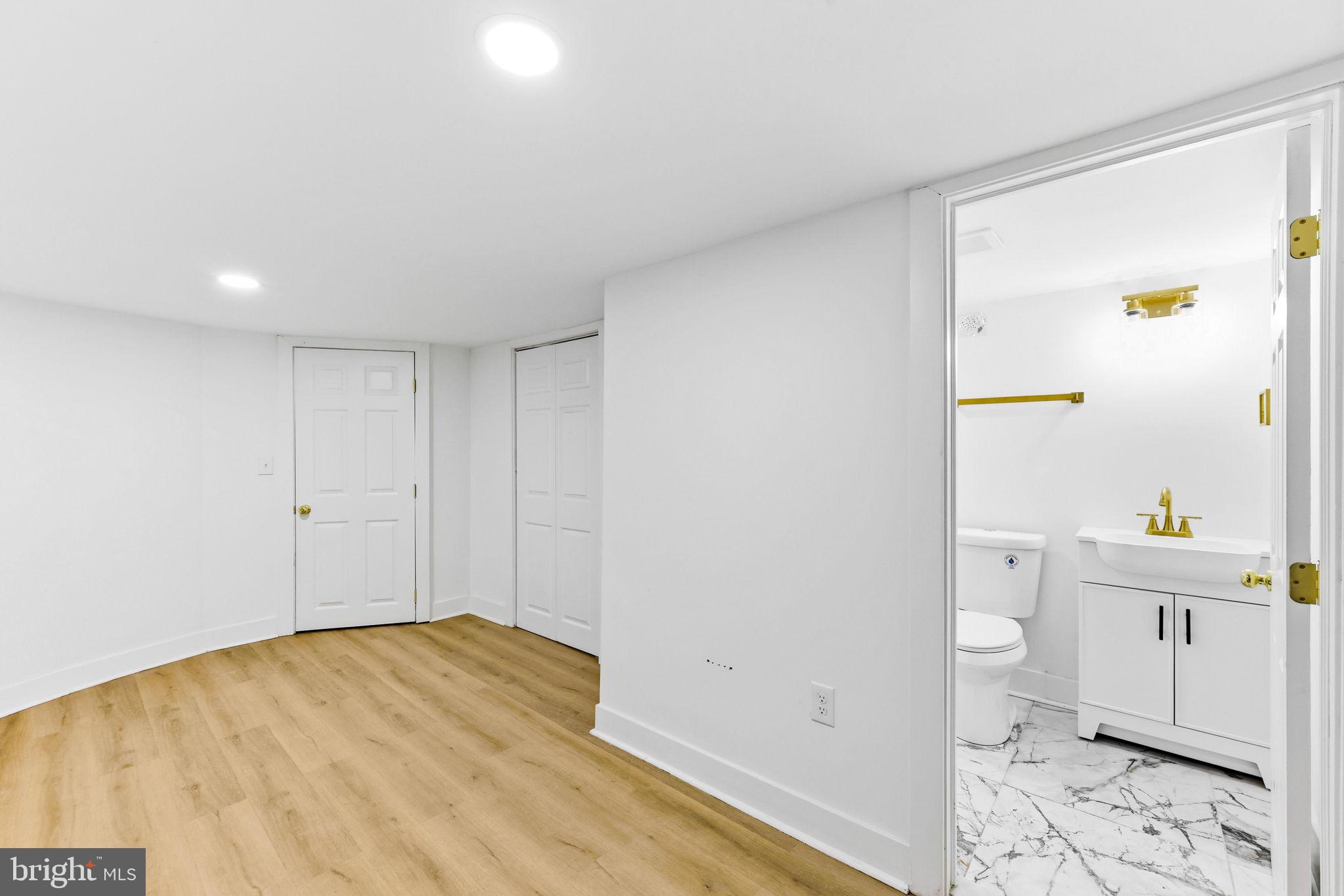 3618 Keswick Road Baltimore, MD 21211 - Photo 34 of 39 a view of bathroom with a toilet sink and mirror