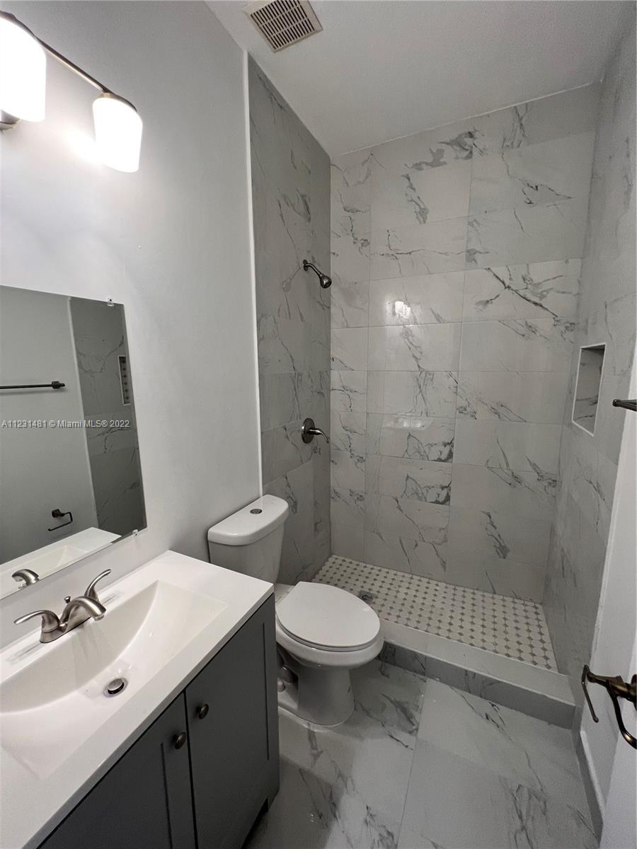 Vizcaya Miramar, FL 33027 - Photo 11 of 15 a bathroom with a sink a toilet and shower