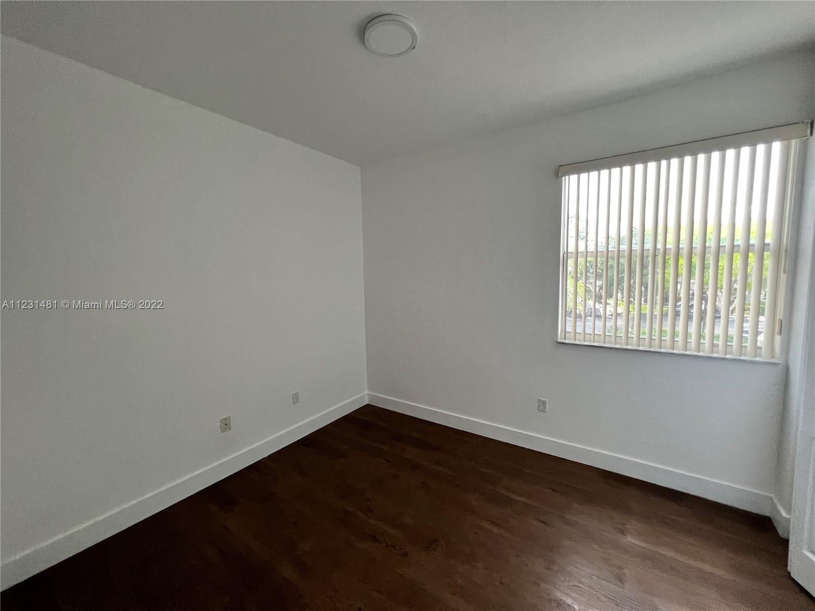 Vizcaya Miramar, FL 33027 - Photo 12 of 15 an empty room with wooden floor and windows