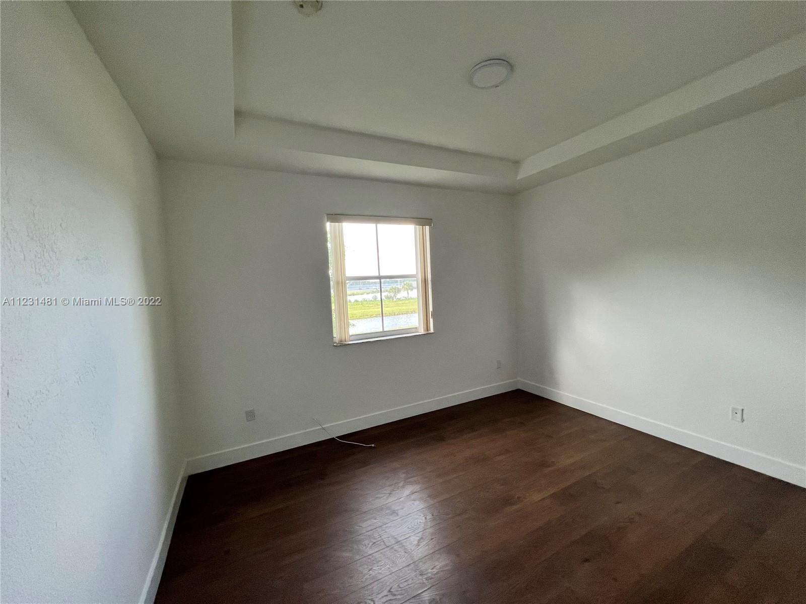 Vizcaya Miramar, FL 33027 - Photo 9 of 15 an empty room with wooden floor and windows