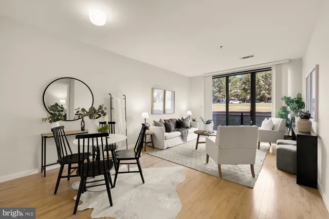 a living room with furniture a table and a large window