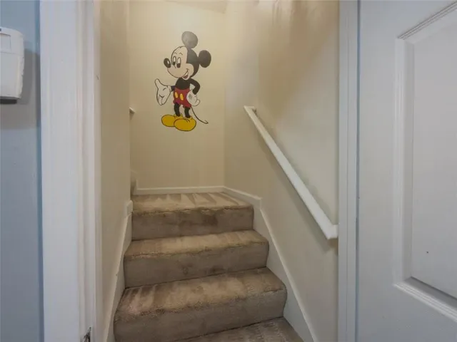 a view of a big room with wooden floor closet and windows