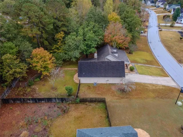 an aerial view of residential houses with outdoor space and parking