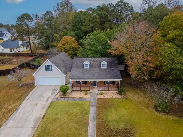 a aerial view of a house with swimming pool next to a yard