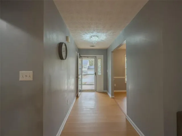 a view of a hallway with wooden shelves