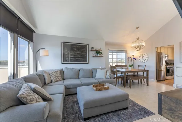 a living room with furniture wooden floor and a large window