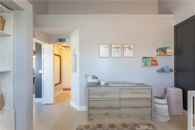 a bedroom with a bed and a refrigerator