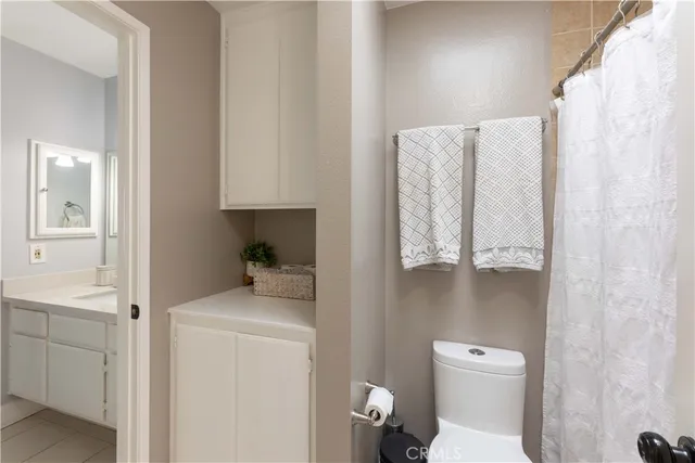 a bathroom with a toilet sink vanity and tub