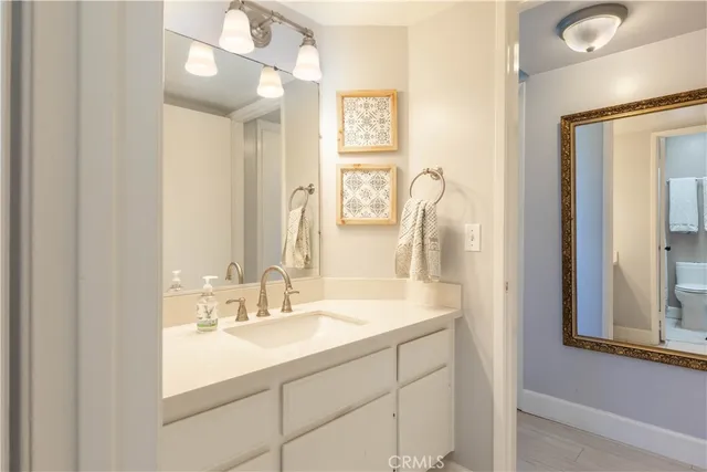 a bathroom with a sink vanity and a mirror