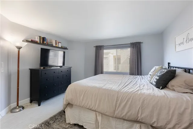 a bedroom with a bed and a mirror