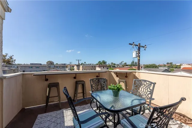 a terrace with outdoor seating and city view