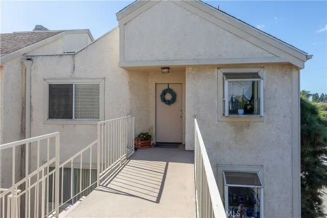 a view of a house with wooden floor and a small yard