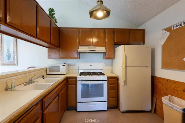 a kitchen with a refrigerator and a sink