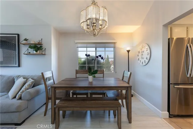 a view of a dining room with furniture a chandelier and wooden floor