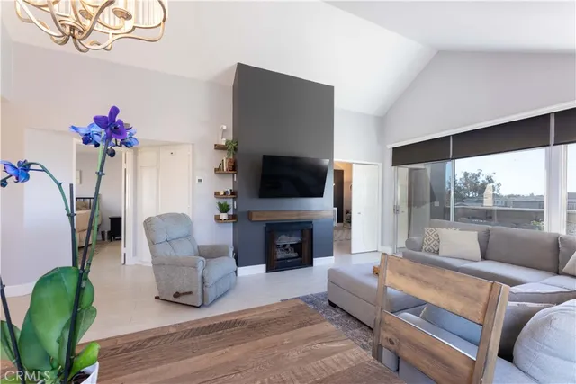 a living room with fireplace furniture and a flat screen tv