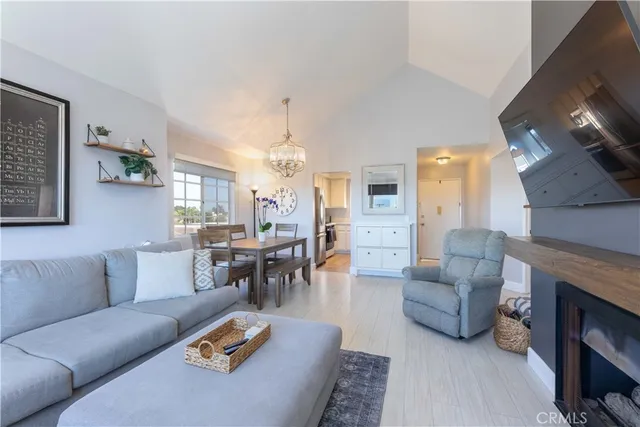a living room with furniture kitchen view and a fireplace