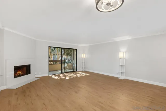 a view of an empty room with a fireplace and a window