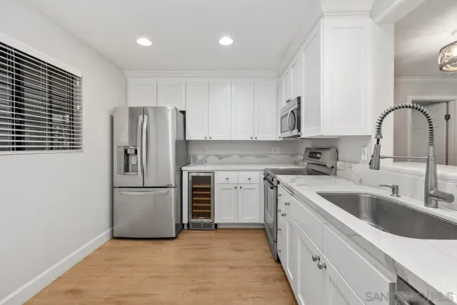 a kitchen with refrigerator a sink and cabinets