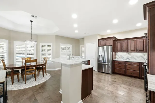 a kitchen with granite countertop stainless steel appliances and wooden cabinets