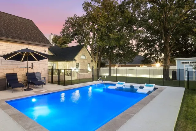 an aerial view of a house with swimming pool
