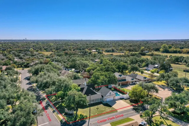 an aerial view of a house with a yard and garden