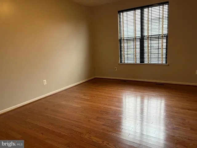 a view of an empty room and wooden floor