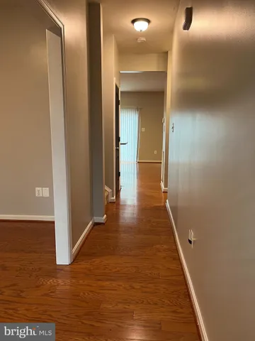 a view of hallway with wooden floor