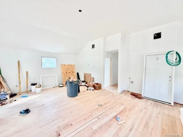 a bedroom with a bed and a large mirror