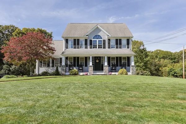 a front view of a house with swimming pool having outdoor seating