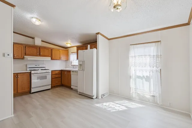 a kitchen with stainless steel appliances a refrigerator and a stove top oven
