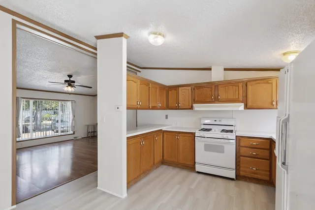 a kitchen with a stove a sink and a window