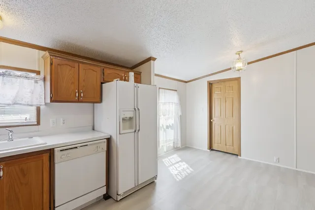 a kitchen with a refrigerator sink stove and cabinets