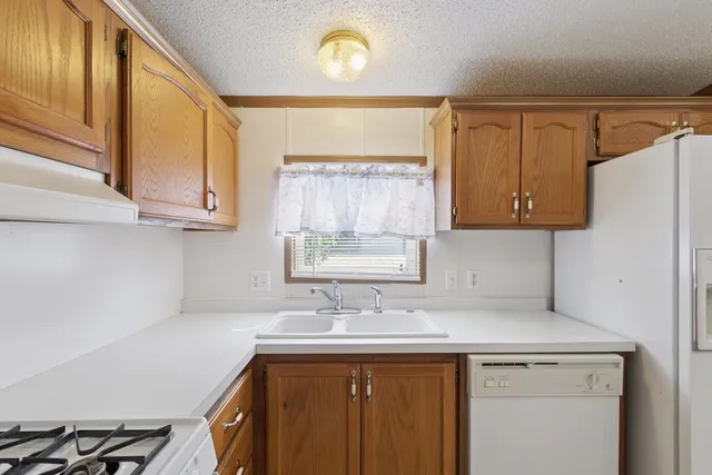 a kitchen with a sink cabinets and a stove top oven