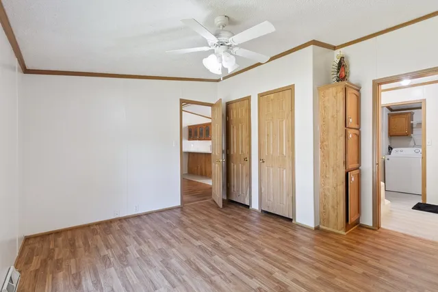 a view of an empty room with wooden floor