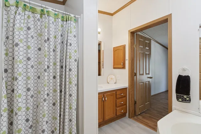 a bathroom with a granite countertop sink a toilet and shower
