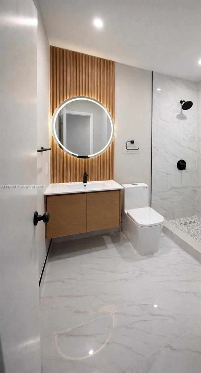 5935 West 16th Lane Hialeah, FL 33012 - Photo 11 of 15 a bathroom with a tub a sink and a shower