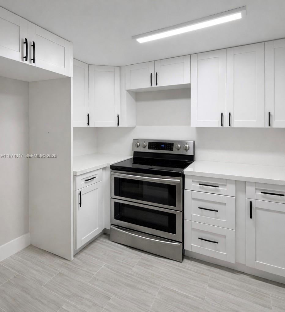 5935 West 16th Lane Hialeah, FL 33012 - Photo 7 of 15 a kitchen with cabinets and appliances