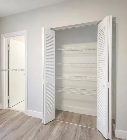 a view of walk in closet with empty racks