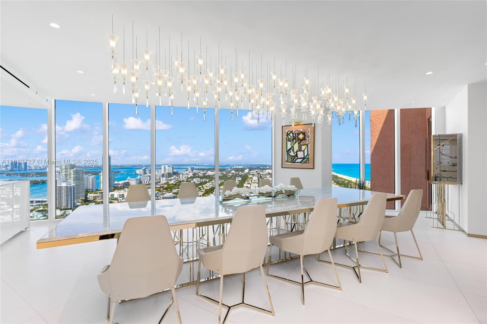 300 South Pointe Drive, Unit PH5 Miami Beach, FL 33139 - Photo 1 of 52 a view of a dining room with furniture a chandelier and kitchen view