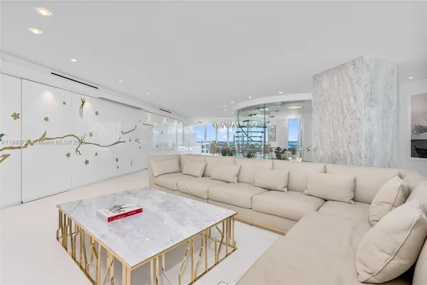 a living room with furniture and kitchen view